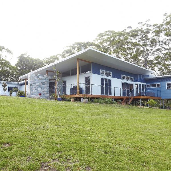 Sustainable eco-home design featuring the 'Hilltop Hideaway' project by Living Green Designer Homes, showcasing modern architecture, expansive outdoor areas, and integration with natural surroundings.