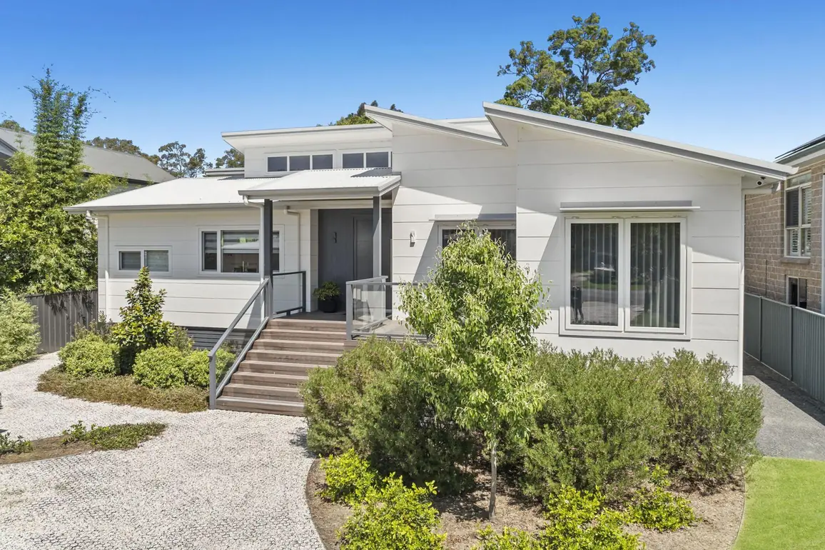 Completed modern custom home with weatherboard cladding and landscaped entry on the Central Coast