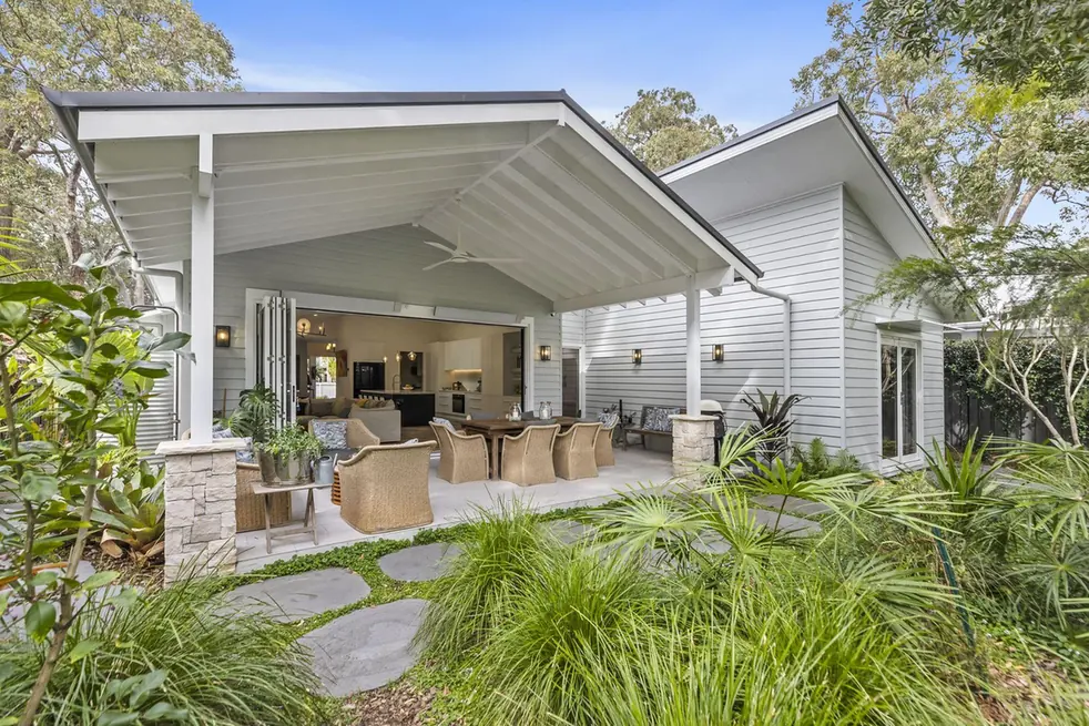 Custom Central Coast home with a covered alfresco and outdoor dining opening onto a landscaped garden