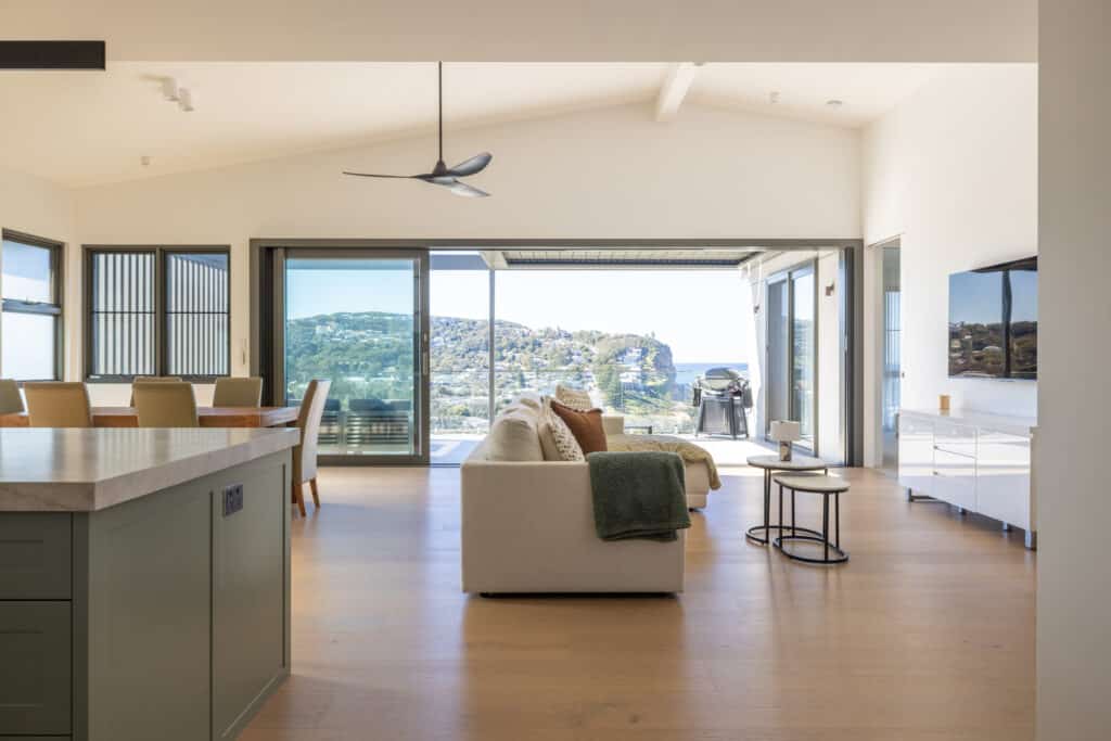 Open plan kitchen, living & dining opening up onto large balcony with ocean views