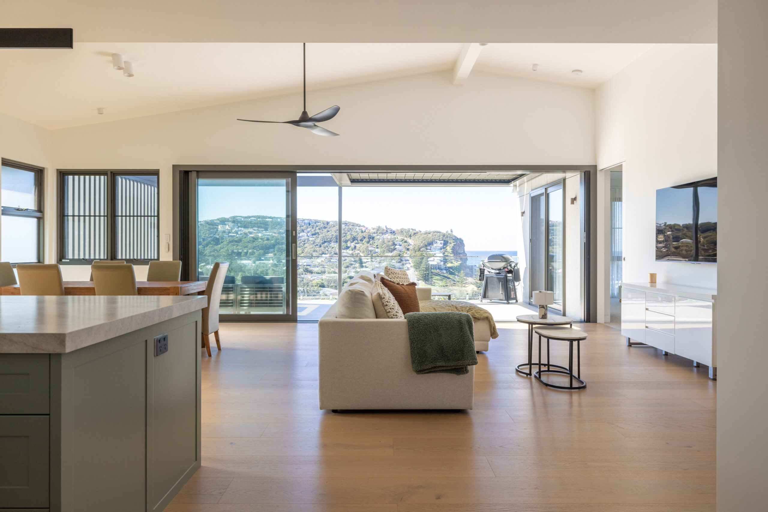 Open plan kitchen, living & dining opening up onto large balcony with ocean views